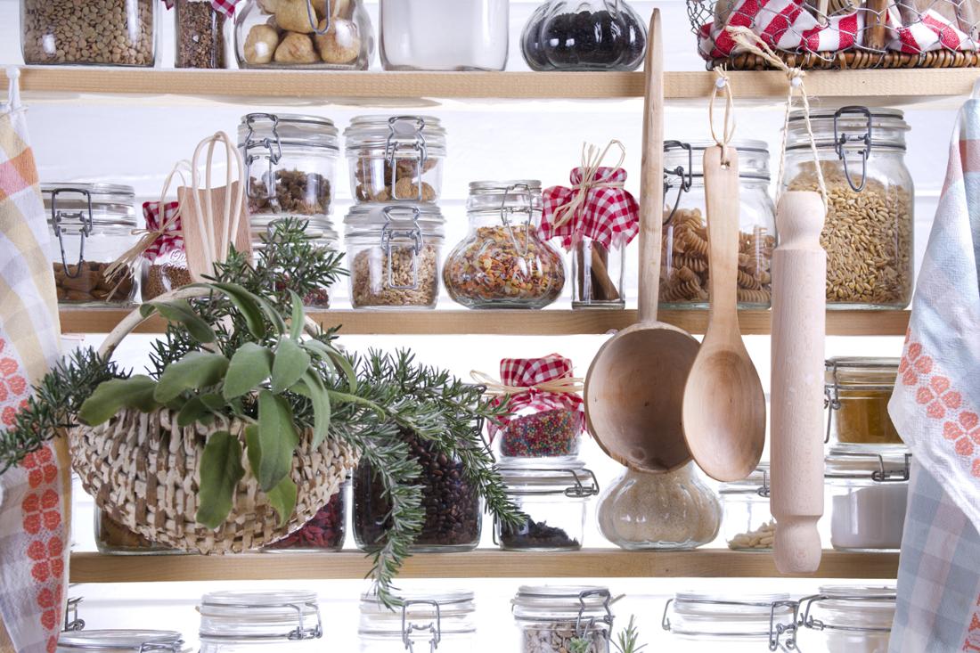 A small pantry with ingredients sorted in jars.